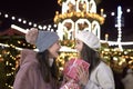 Women exchanging gifts on Christmas market Royalty Free Stock Photo