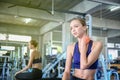 Women exercise already painful. Young caucasian female having pain in her neck while workout at the gym. Woman feeling strong pain Royalty Free Stock Photo