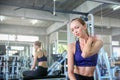 Women exercise already painful. Young caucasian female having pain in her neck while workout at the gym. Woman feeling strong pain Royalty Free Stock Photo