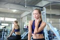 Women exercise already painful. Young caucasian female having pain in her neck while workout at the gym. Woman feeling strong pain Royalty Free Stock Photo