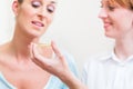 Women explaining homeopathy globuli Royalty Free Stock Photo