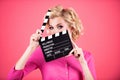 Women eyes through clapper board. Movie production clapper board, film. Clapperboard film industry. Pretty girl holding Royalty Free Stock Photo