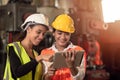 Women in factory engineer mix race working together using tablet happy smile Royalty Free Stock Photo