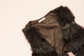 Women fashion brown faux suede fringe vest. Pastel punchy pink background. Concept of fashion and design, shopping