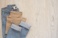 Women fashion clothes on wooden background. Flat lay of female styled look. Polo blouse and jeans. Top view. Shopping Concept.