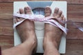 Women feet measuring weight on scale machine