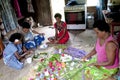 Fijian women plaiting flowers for hair