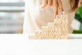 Women fingers climb up wooden block closeup