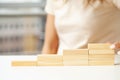 Women fingers climb up wooden block closeup