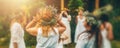 Women in flower wreath on sunny meadow, Floral crown, symbol of summer solstice. Royalty Free Stock Photo