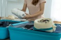 Women fold  clothes into bags to prepare for the upcoming vacation. Packing suitcase Royalty Free Stock Photo