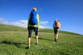 Women friends hiking in grassland mountains