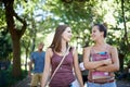 Women, friends and talking of education on campus with learning, knowledge and books at college. Happy students with Royalty Free Stock Photo