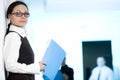 Women in glasses with blue folder Royalty Free Stock Photo