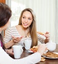 Women gossiping and drinking tea in home Royalty Free Stock Photo