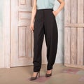 Women gray pants, torso, hand in pocket, classic fashionable clothes.