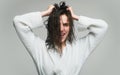 Women hair care. Young brunette woman with nourished long hair, studio shot.