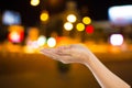 Women hand on City night light blur bokeh , bokeh background. Royalty Free Stock Photo