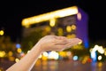 Women hand on City night light blur bokeh , bokeh background. Royalty Free Stock Photo