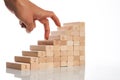 Women hand finger walk on stacked wooden block