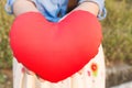 Women hand gently hold red heart with love, careness and restpect with copy sapce