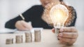 Women hand hold light bulb with icons work on the desk, Creativity and innovation are keys success. Concept of new idea and innova Royalty Free Stock Photo