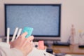 A women hand hold the remote control of the TV box in the living room, the blank screen TV Royalty Free Stock Photo