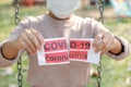 The women hand holding covid19 paper make a symbol fight in disaster covid19, and wearing the mask