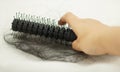 Women hand holding loss hair comb Royalty Free Stock Photo