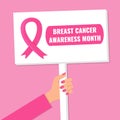 Women Hand holding protest sign. Breast cancer awareness month concept. Pink ribbon symbol. Royalty Free Stock Photo