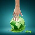 Women hand pointing down to the green globe Royalty Free Stock Photo