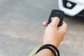 Women hand presses on the remote control car alarm system Royalty Free Stock Photo