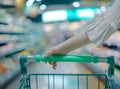 women hand push shopping cart ,supermarket , abstract blurred photo of store with trolley in department store blurred Royalty Free Stock Photo