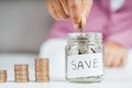 Women hand putting money coin into glass jar for saving money. saving money and financial concept Royalty Free Stock Photo