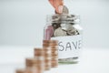 Women hand putting money coin into glass jar for saving money. saving money and financial concept Royalty Free Stock Photo