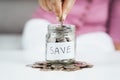 Women hand putting money coin into glass jar for saving money. saving money and financial concept Royalty Free Stock Photo
