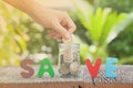 Women hand putting money coin in jar. concept saving money grow Royalty Free Stock Photo