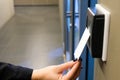 Women hand reaching to use RFID key card to access to office building area and workspace. In building security only for authorized Royalty Free Stock Photo