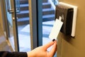 Women hand reaching to use RFID key card to access to office building area and workspace. In building security only for authorized Royalty Free Stock Photo