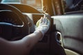 Woman hands in rubber glove cleaning in modern car,Cleansing car interior for protection from virus disease