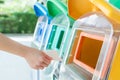 Women hand throwing away the garbage to the bin/trash, sorting waste/garbage before drop to the bin Royalty Free Stock Photo