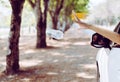 Woman hand throwing plastic bottle trash on the road,Environment and pollution campaign concept Royalty Free Stock Photo