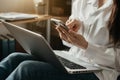 Women hand using smart phone and laptop payments online shopping, omni channel, digital laptop docking keyboard computer at office Royalty Free Stock Photo