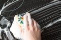 Women hand washing the black electric stove with soap detergent