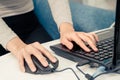 Women hand is working on the laptop and touch the mouse on the other hand Royalty Free Stock Photo