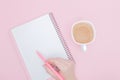 Women hand with writing on note book blank on the pink background, instagram and business concept Royalty Free Stock Photo