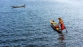 A woman with handcrafted colorful lotus fabrics on her boat in In Dain Khone village, on Inle Lake, Myanmar.