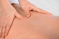 Women hands doing massage on the back, very close-up soft light