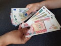 women hands exchanging European banknotes and Cuban money