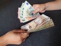 women hands exchanging European banknotes and Peruvian money